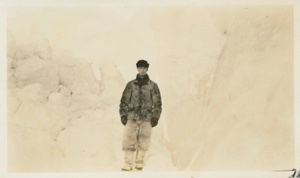 Image of Donald B. MacMillan standing between bergs